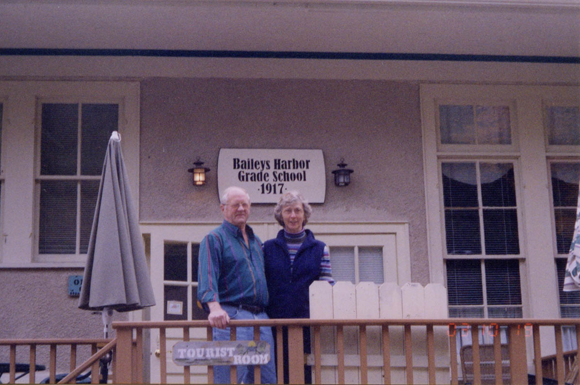 Loren and Annie Peil outside of the schoolhouse building in 2003